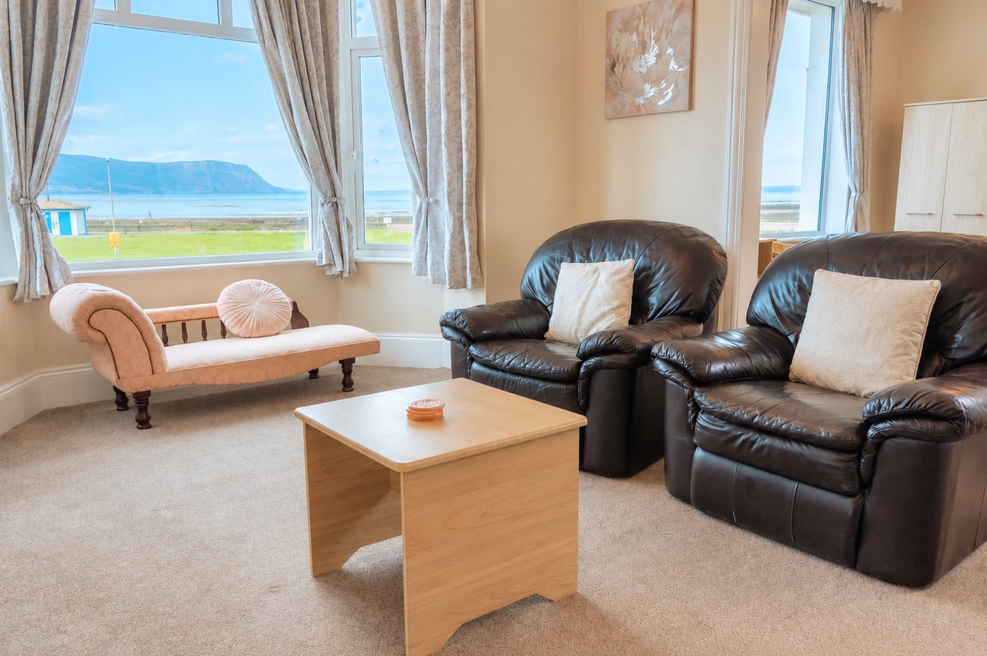 Bay-window lounge of a sea-view suite at Plas Gorwelion, looking over West Shore